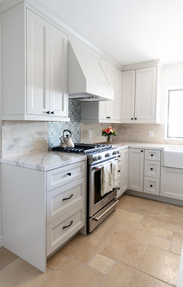 Inspiration for a large country u-shaped kitchen in Phoenix with a belfast sink, shaker cabinets, green cabinets, engineered stone countertops, white splashback, brick splashback, stainless steel appliances, terrazzo flooring, an island, beige floors and white worktops.