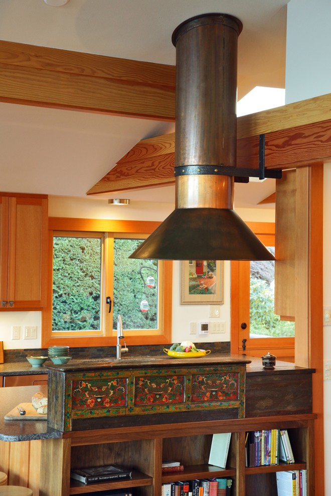 Photo of a bohemian l-shaped open plan kitchen in Seattle with a built-in sink, shaker cabinets, medium wood cabinets, composite countertops, brown splashback, stone tiled splashback and stainless steel appliances.