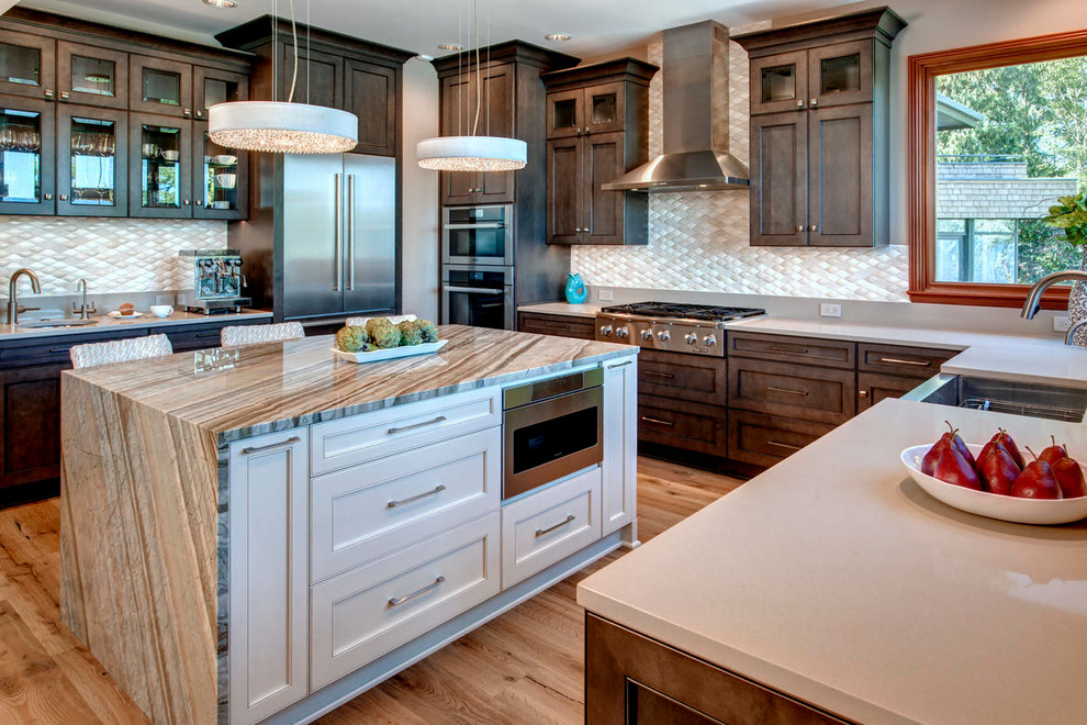 Example of a transitional kitchen design in Seattle with an island