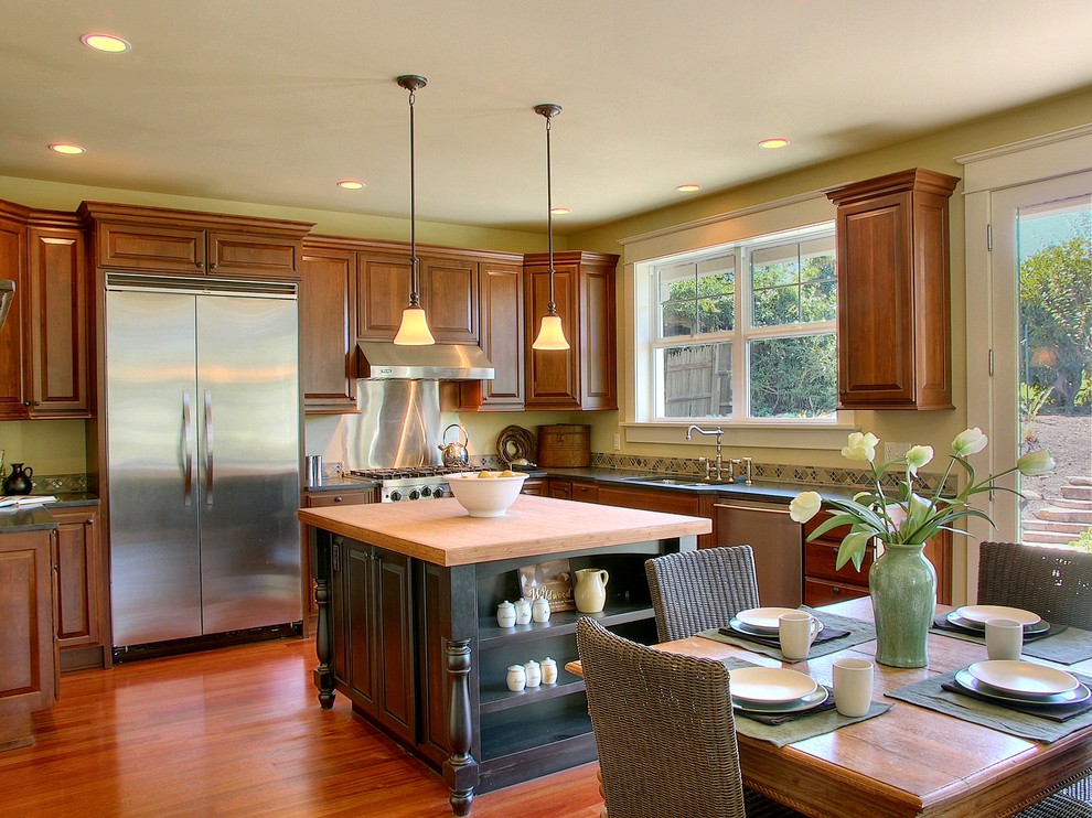 This is an example of a traditional kitchen in Seattle with raised-panel cabinets and stainless steel appliances.