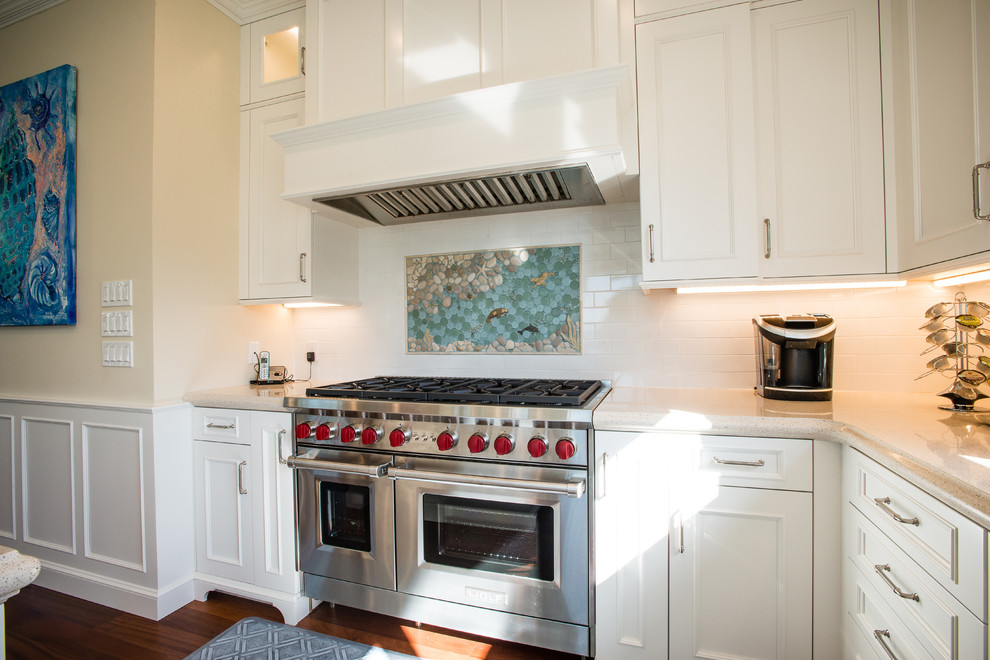 Large beach style l-shaped dark wood floor eat-in kitchen photo in Miami with a farmhouse sink, beaded inset cabinets, white cabinets, quartz countertops, white backsplash, subway tile backsplash, paneled appliances and an island