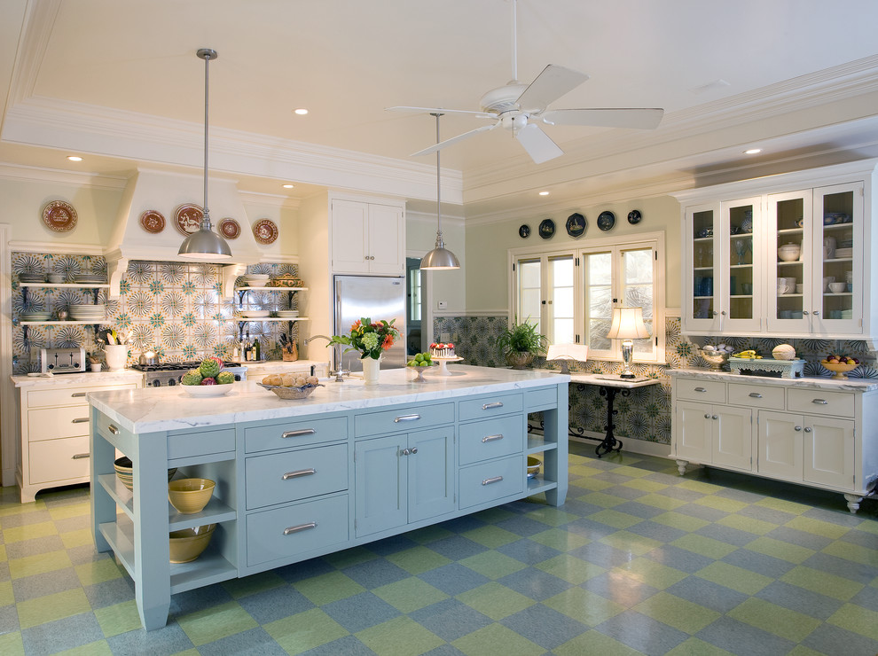 Photo of a large mediterranean u-shaped enclosed kitchen in Santa Barbara with a belfast sink, shaker cabinets, white cabinets, marble worktops, multi-coloured splashback, cement tile splashback, stainless steel appliances, an island and multi-coloured floors.