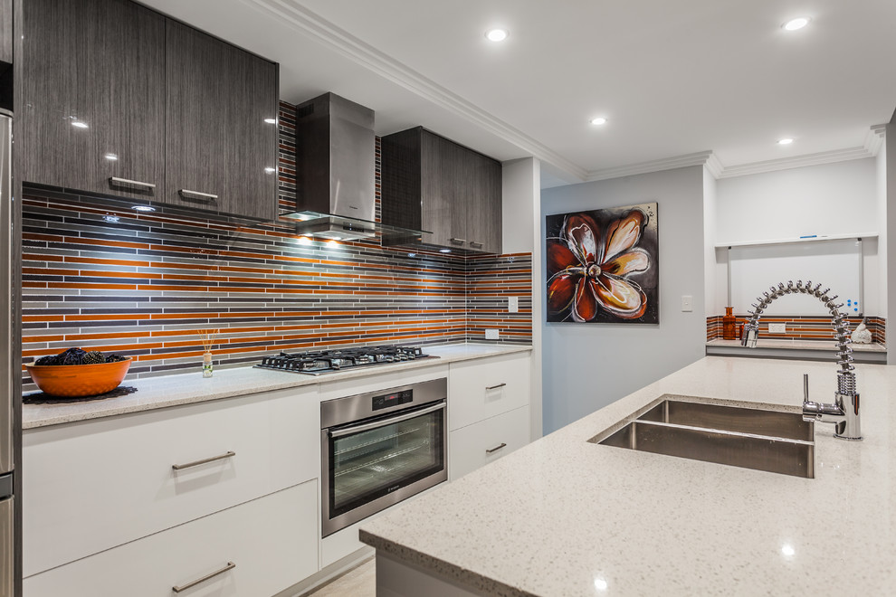 Offene, Zweizeilige Moderne Küche mit Doppelwaschbecken, flächenbündigen Schrankfronten, weißen Schränken, bunter Rückwand, Küchengeräten aus Edelstahl und Kücheninsel in Perth