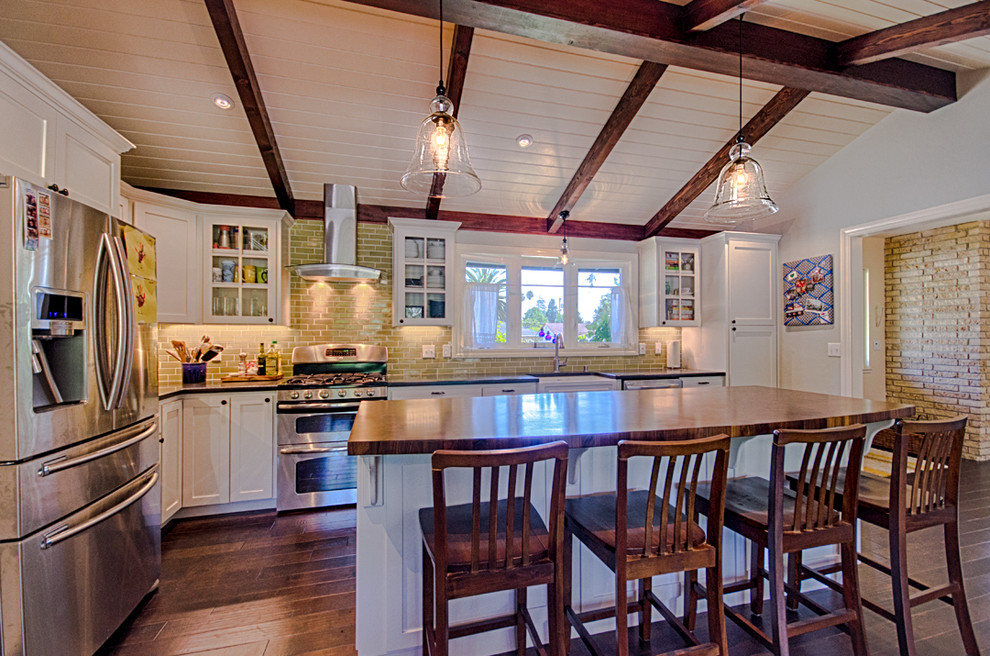 Foto på ett mellanstort lantligt kök, med en enkel diskho, skåp i shakerstil, vita skåp, granitbänkskiva, beige stänkskydd, stänkskydd i keramik, rostfria vitvaror, mellanmörkt trägolv och en köksö