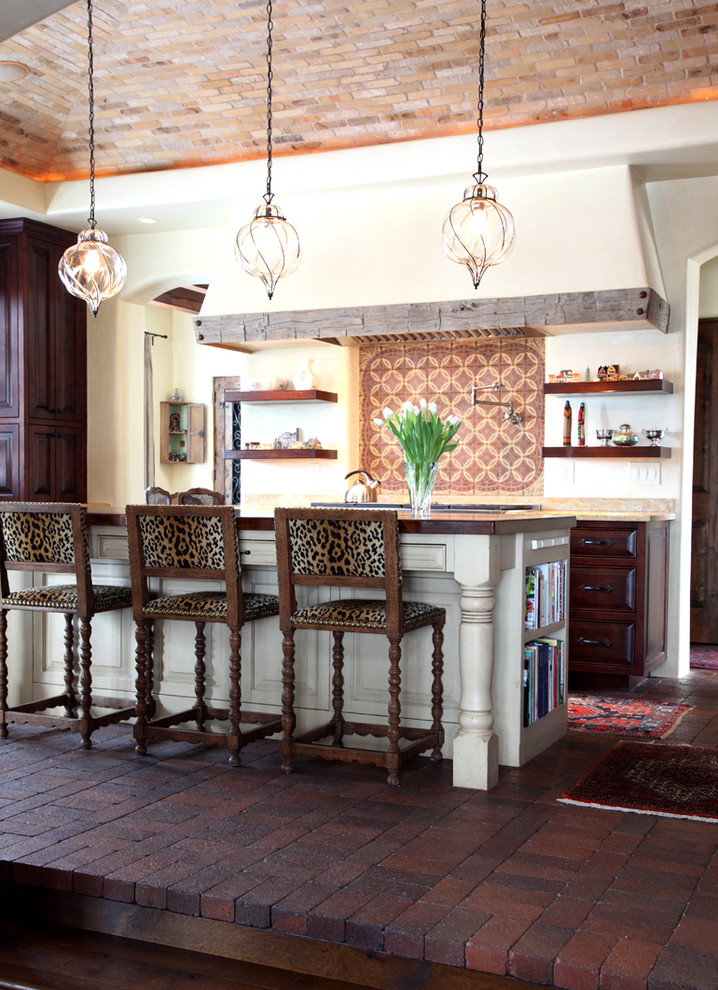 Kitchen - mediterranean galley brick floor kitchen idea in Seattle with raised-panel cabinets and dark wood cabinets