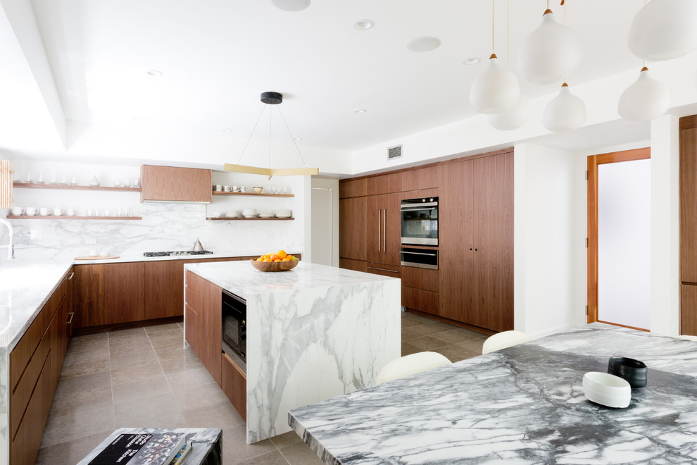 This is an example of a large contemporary l-shaped kitchen/diner in Los Angeles with a submerged sink, flat-panel cabinets, brown cabinets, marble worktops, white splashback, marble splashback, integrated appliances, ceramic flooring, an island and grey floors.