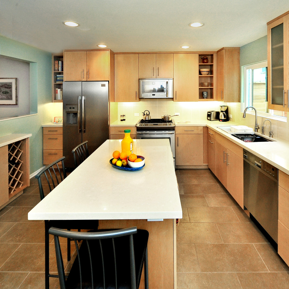 Eat-in kitchen - contemporary l-shaped ceramic tile eat-in kitchen idea in Los Angeles with stainless steel appliances, an undermount sink, flat-panel cabinets, light wood cabinets, quartz countertops, beige backsplash, porcelain backsplash and an island
