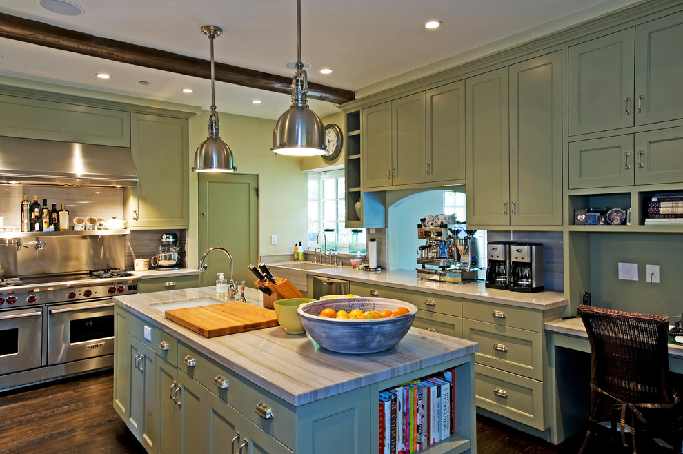 Mid-sized elegant l-shaped enclosed kitchen photo in Los Angeles with stainless steel appliances, quartzite countertops, a farmhouse sink, shaker cabinets, green cabinets, stone slab backsplash and an island
