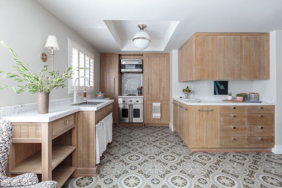 Country u-shaped kitchen in Los Angeles with a submerged sink, flat-panel cabinets, light wood cabinets, multi-coloured splashback, ceramic splashback, stainless steel appliances, no island, multi-coloured floors and grey worktops.
