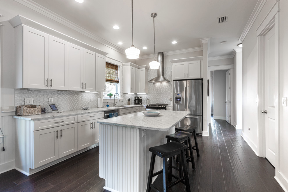 Enclosed kitchen - transitional l-shaped dark wood floor and brown floor enclosed kitchen idea in Miami with an undermount sink, shaker cabinets, white cabinets, gray backsplash, mosaic tile backsplash, stainless steel appliances, an island and gray countertops