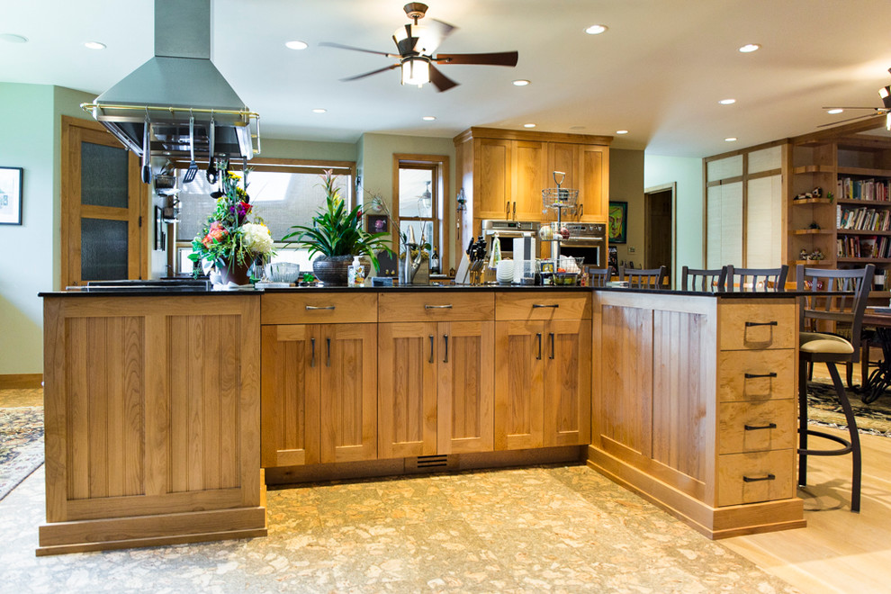 Large rustic u-shaped open plan kitchen in Salt Lake City with shaker cabinets, light wood cabinets and an island.