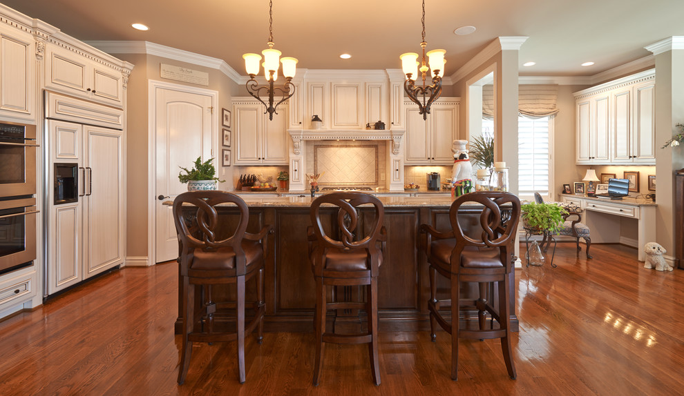 Inspiration for a large timeless single-wall medium tone wood floor kitchen remodel in Richmond with raised-panel cabinets, white cabinets, granite countertops, beige backsplash, cement tile backsplash, paneled appliances and an island
