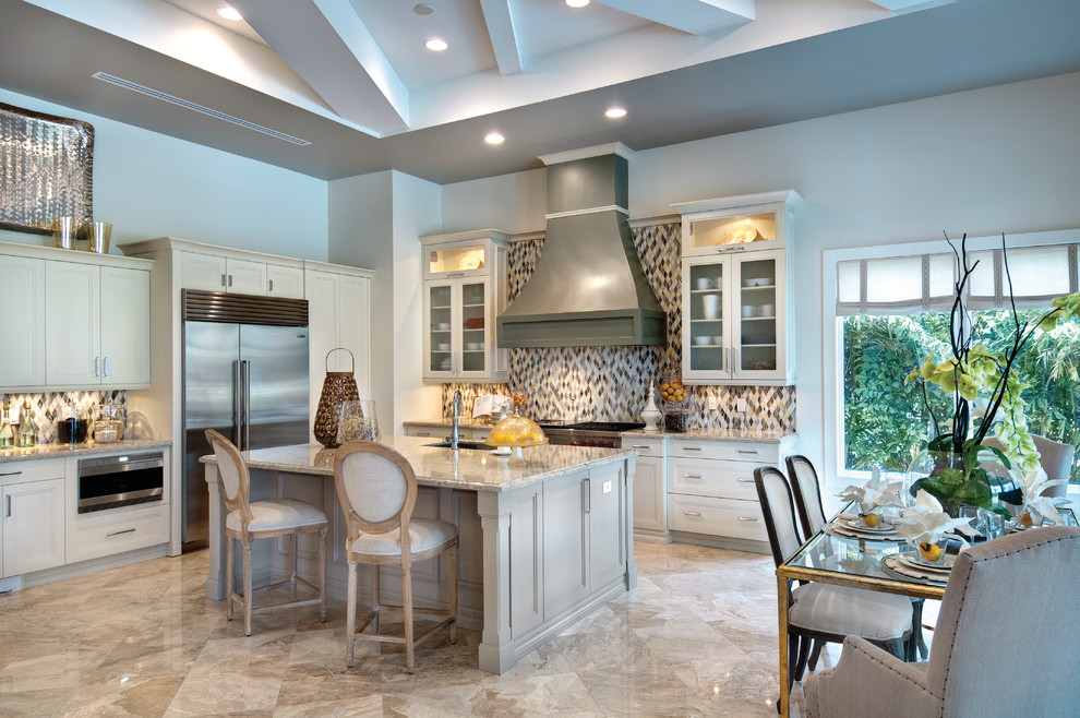 Large tuscan u-shaped marble floor open concept kitchen photo in Miami with an undermount sink, recessed-panel cabinets, gray cabinets, granite countertops, multicolored backsplash, mosaic tile backsplash, stainless steel appliances and an island