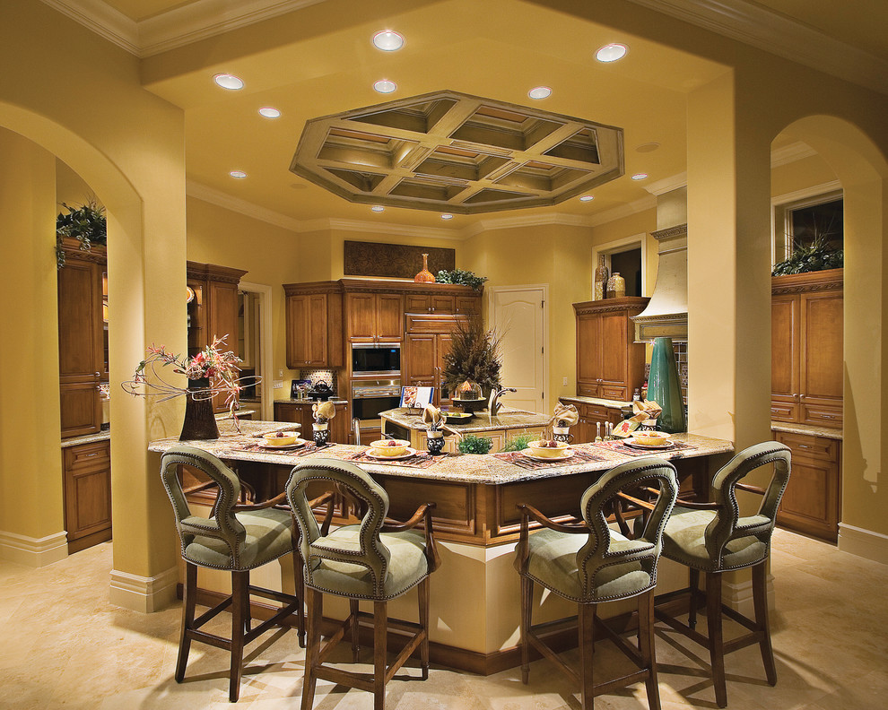 Example of a large tuscan u-shaped travertine floor open concept kitchen design in Miami with an undermount sink, raised-panel cabinets, medium tone wood cabinets, granite countertops, multicolored backsplash, stone tile backsplash, paneled appliances and an island