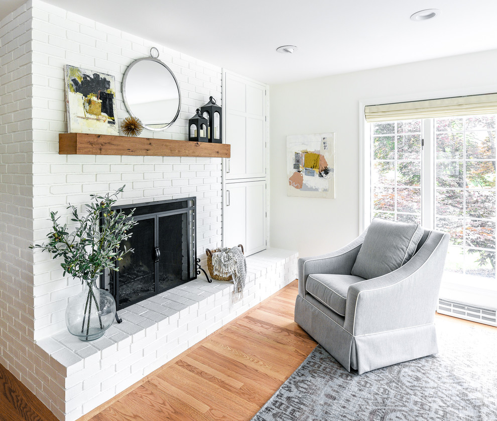 Eat-in kitchen - large transitional l-shaped light wood floor eat-in kitchen idea in Philadelphia with a farmhouse sink, flat-panel cabinets, white cabinets, soapstone countertops, white backsplash, ceramic backsplash, paneled appliances, an island and gray countertops