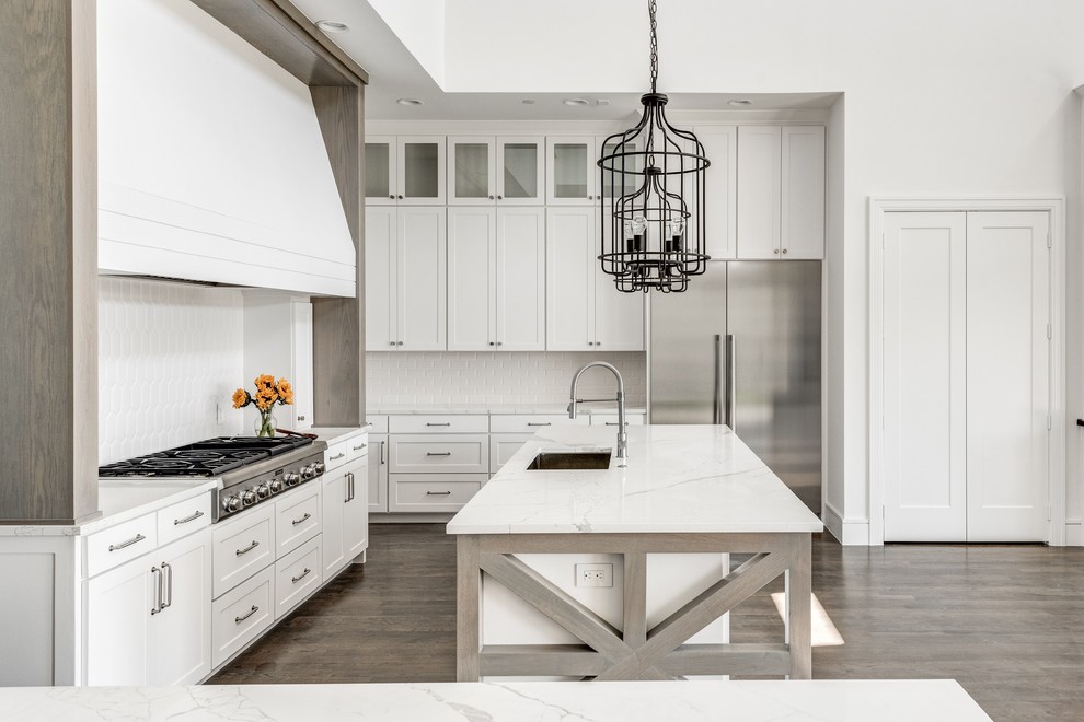 Inspiration for a farmhouse eat-in kitchen remodel in Dallas with white backsplash, stainless steel appliances, an island and white countertops