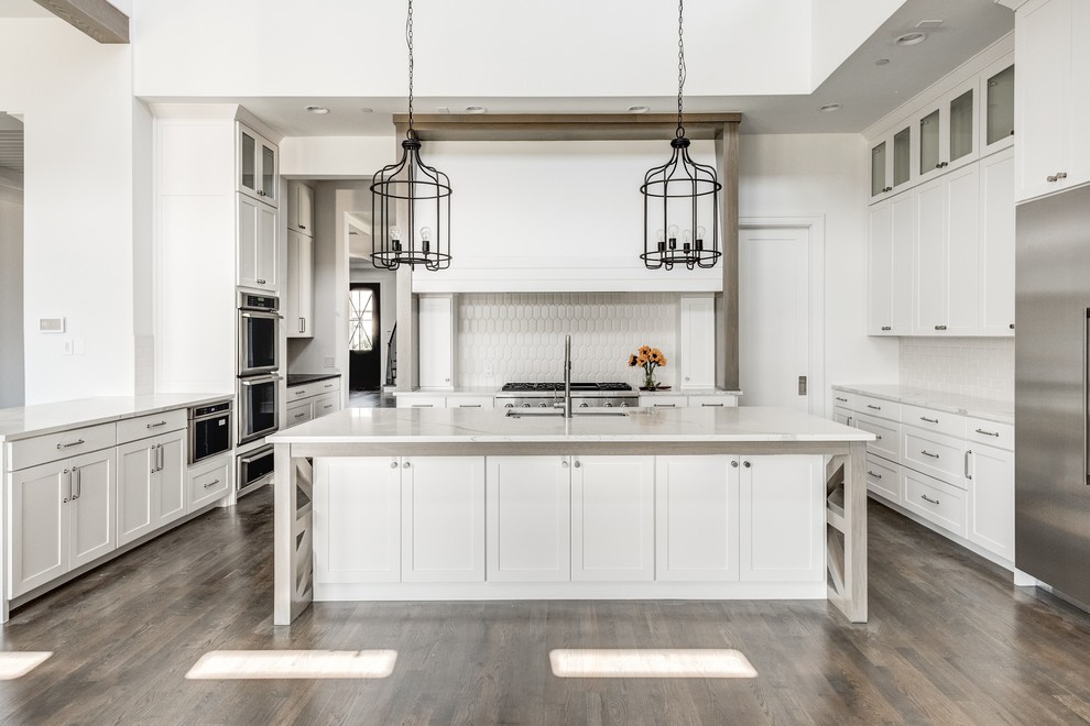 Design ideas for a large rural kitchen in Dallas with white splashback, stainless steel appliances and an island.
