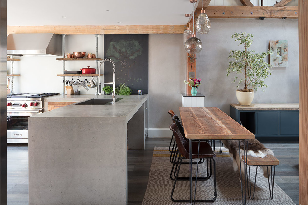 Inspiration for a large contemporary l-shaped open plan kitchen in London with an integrated sink, concrete worktops, grey splashback, light hardwood flooring, no island, grey floors and grey worktops.