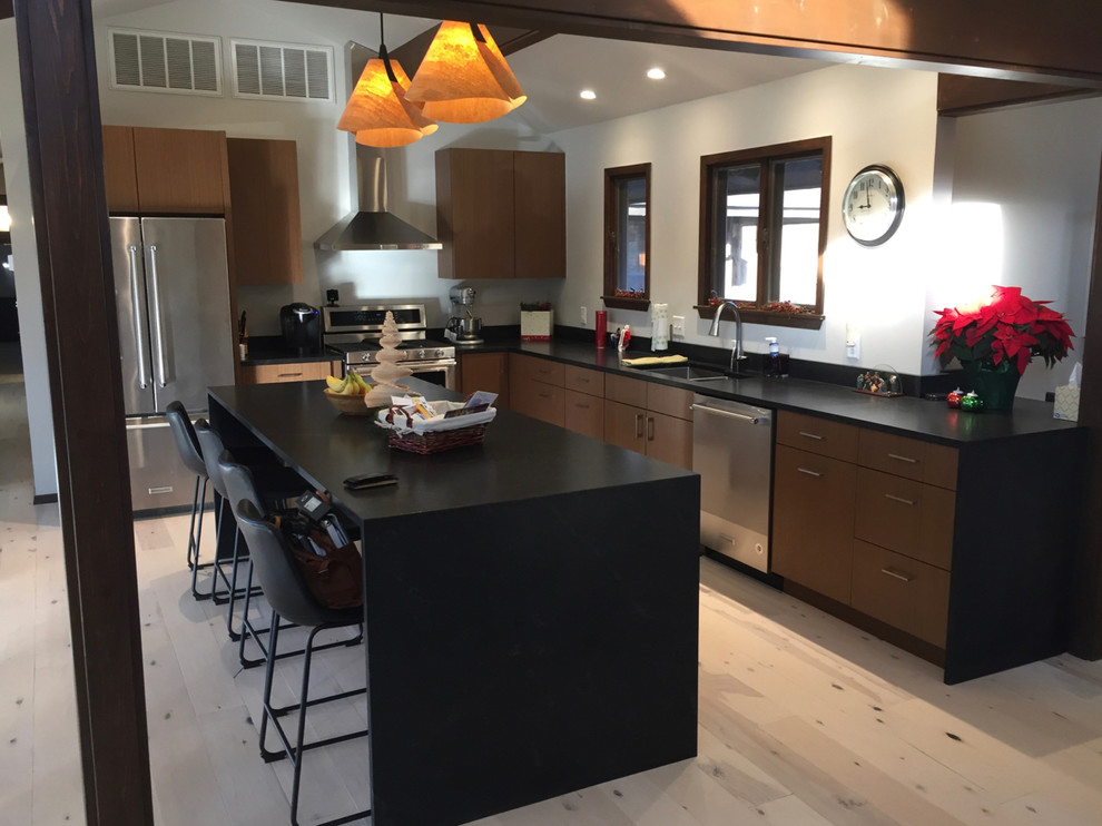 Inspiration for a mid-sized 1960s l-shaped light wood floor and beige floor open concept kitchen remodel in Other with quartz countertops, a double-bowl sink, flat-panel cabinets, medium tone wood cabinets, stainless steel appliances, an island and black countertops