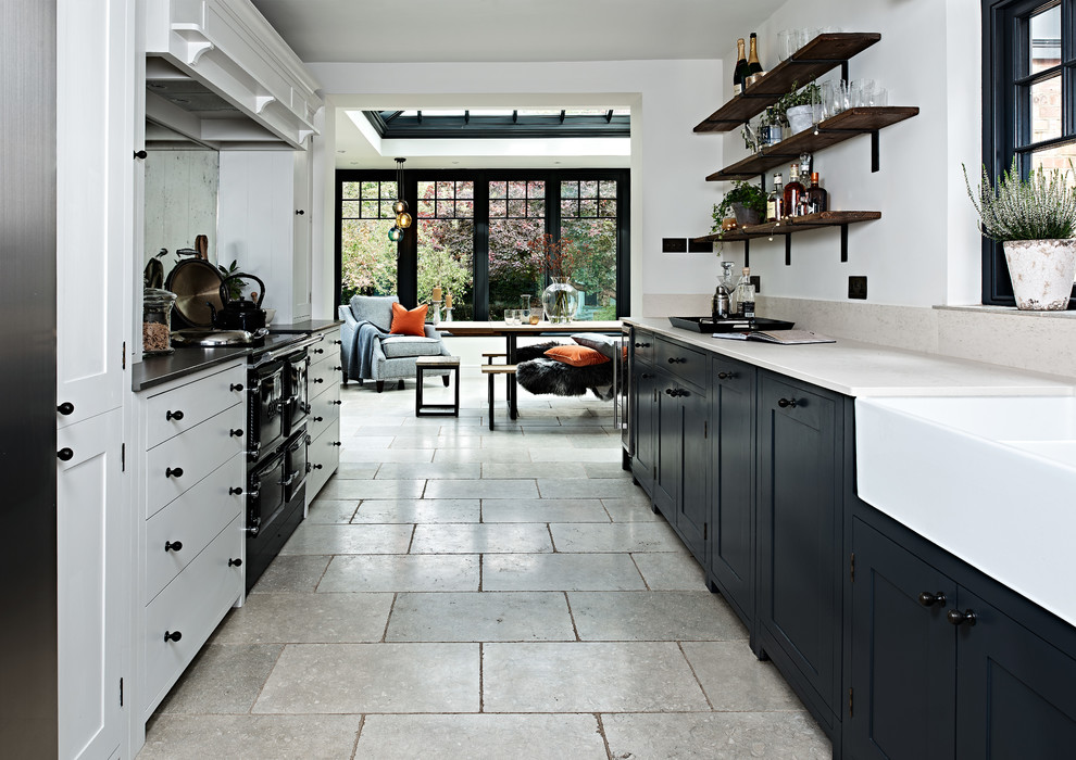 Small danish galley gray floor open concept kitchen photo in Buckinghamshire with shaker cabinets, mirror backsplash, no island and a farmhouse sink