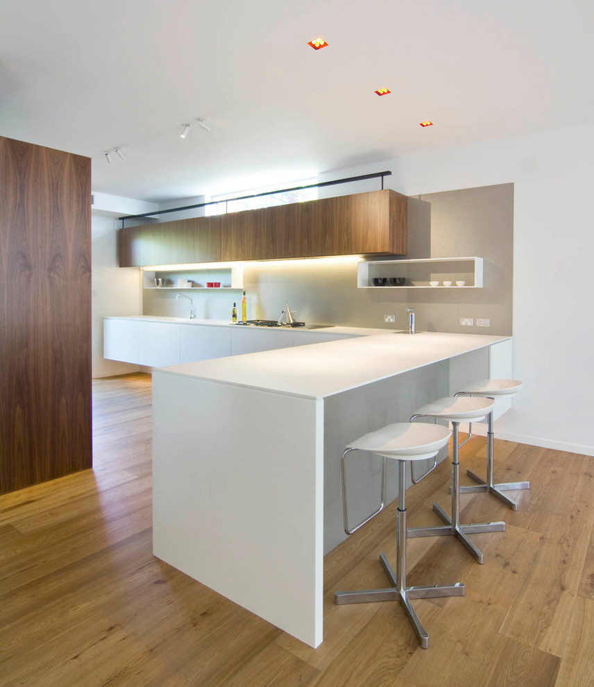 Photo of a large scandinavian l-shaped open plan kitchen in Sydney with engineered stone countertops.