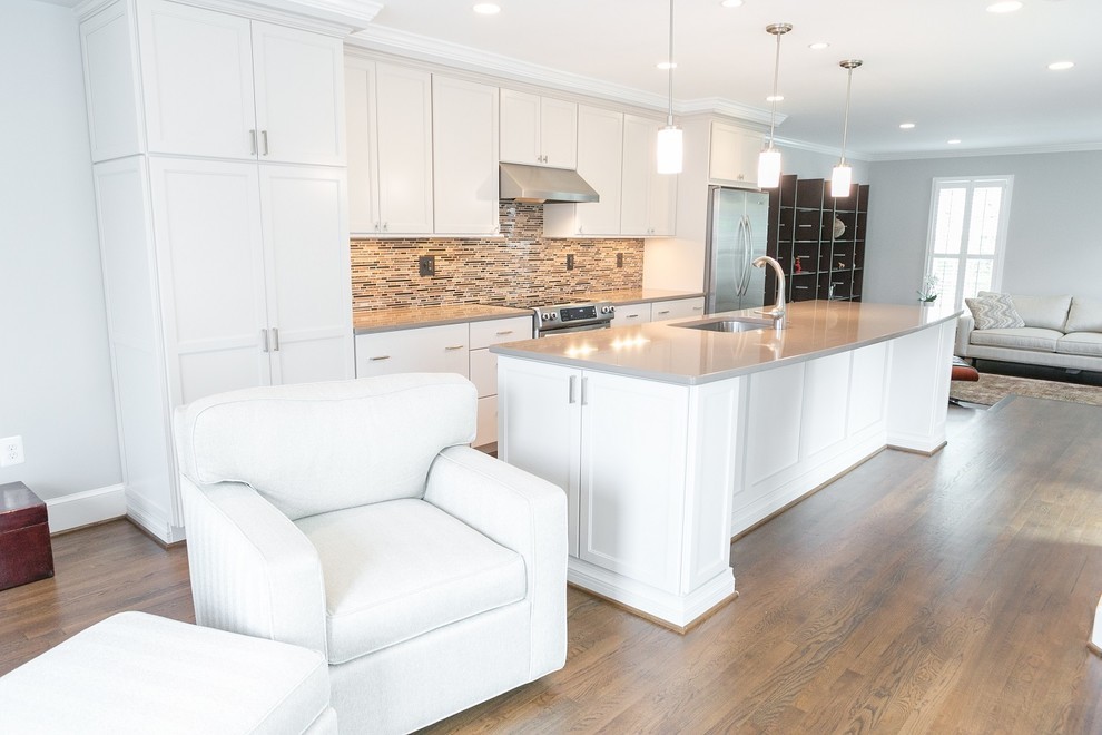 This is an example of a medium sized scandinavian single-wall open plan kitchen in Other with engineered stone countertops, an island and brown floors.