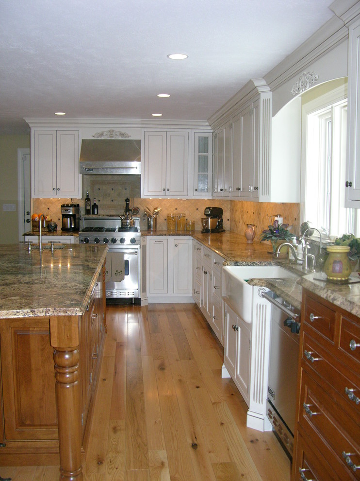 Klassisk inredning av ett stort kök, med en rustik diskho, luckor med profilerade fronter, vita skåp, laminatbänkskiva, flerfärgad stänkskydd, stänkskydd i stenkakel, rostfria vitvaror, ljust trägolv och en köksö
