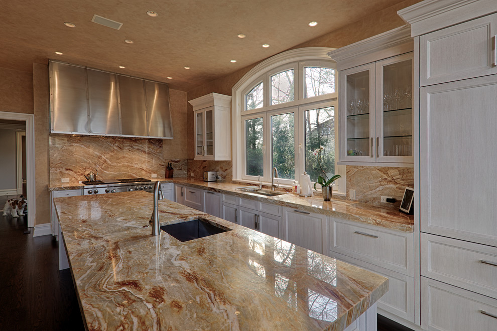 Trendy kitchen photo in New York with quartzite countertops, stone slab backsplash and an island