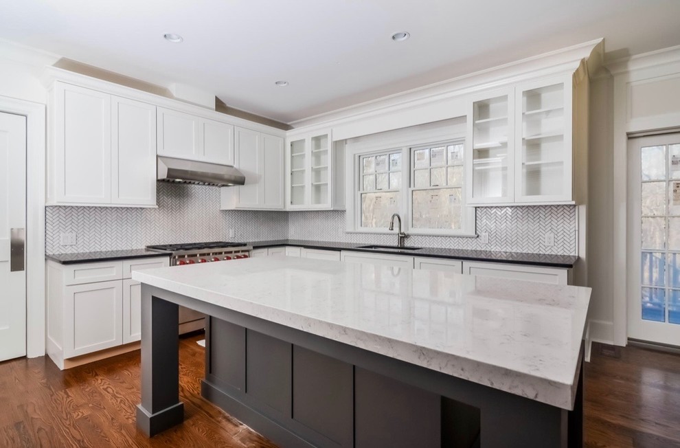 Inspiration for a large transitional l-shaped light wood floor and brown floor eat-in kitchen remodel in Miami with an undermount sink, recessed-panel cabinets, white cabinets, marble countertops, white backsplash, marble backsplash, stainless steel appliances, an island and white countertops
