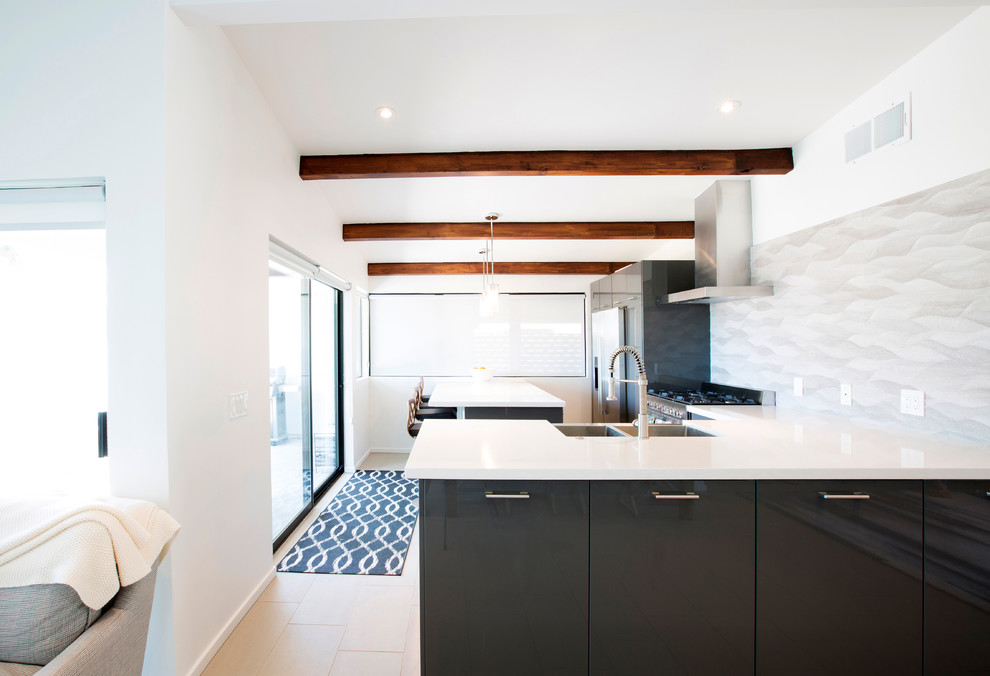 Inspiration for a mid-sized mid-century modern l-shaped porcelain tile open concept kitchen remodel in Phoenix with a farmhouse sink, flat-panel cabinets, gray cabinets, quartz countertops, gray backsplash, porcelain backsplash, stainless steel appliances and an island