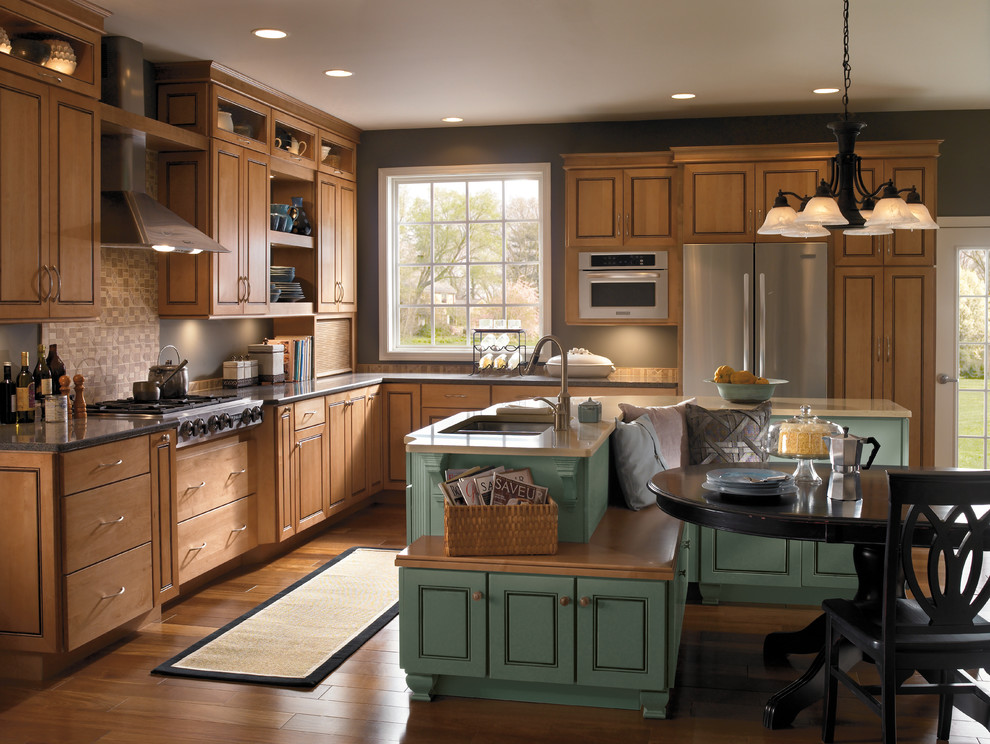 Design ideas for a large rural l-shaped kitchen/diner in Boston with a submerged sink, raised-panel cabinets, medium wood cabinets, granite worktops, stainless steel appliances, medium hardwood flooring, an island, brown floors and brown worktops.