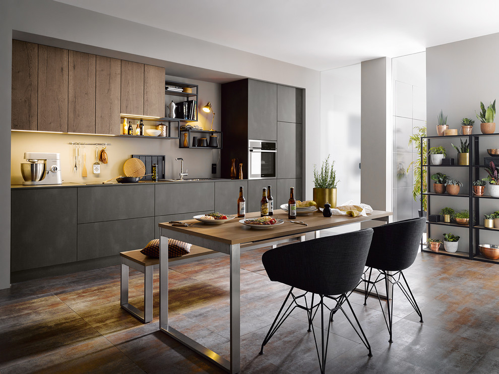 This is an example of a contemporary single-wall kitchen/diner in Other with a built-in sink, flat-panel cabinets, medium wood cabinets, beige splashback and grey floors.