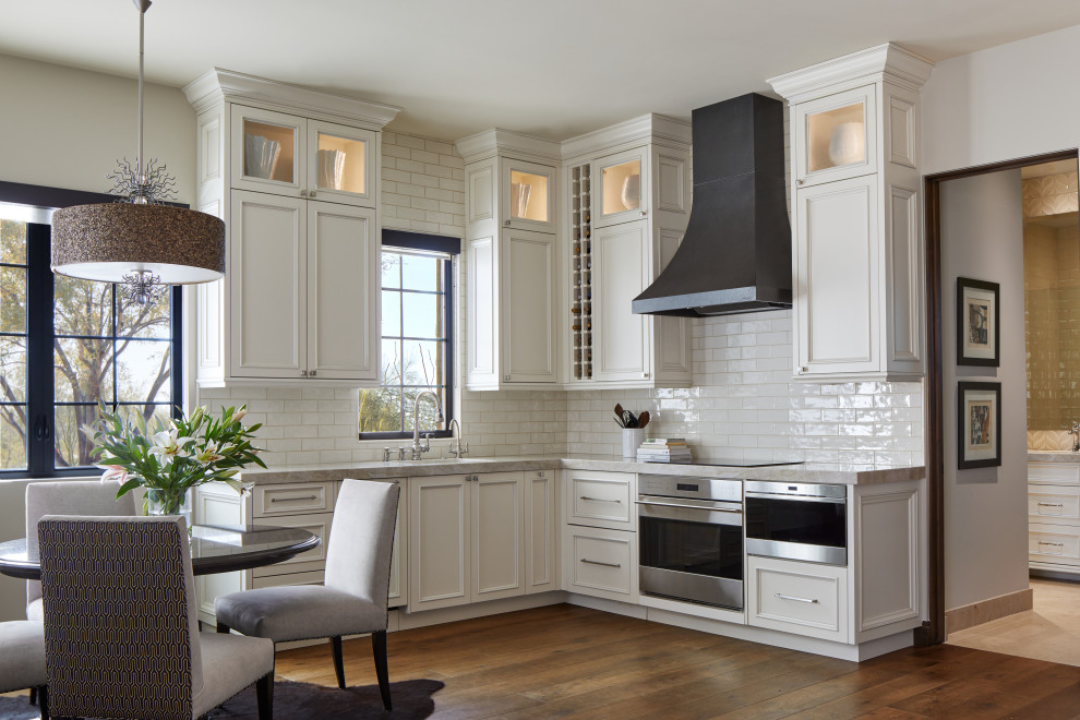 Exempel på ett mellanstort klassiskt grå grått kök, med en undermonterad diskho, luckor med infälld panel, vita skåp, vitt stänkskydd, stänkskydd i keramik, rostfria vitvaror och brunt golv