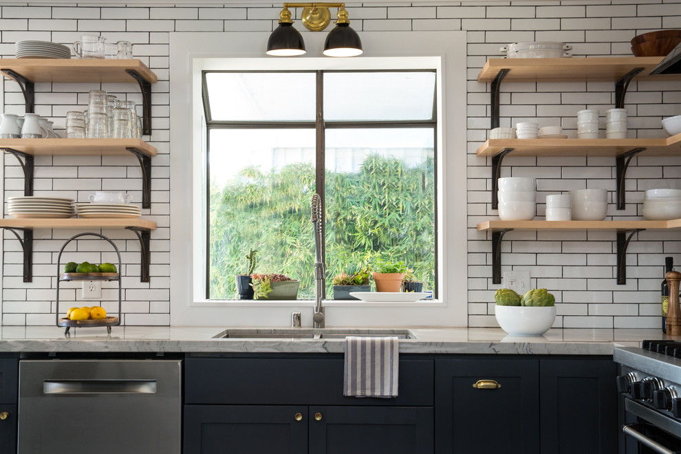 Small eclectic l-shaped dark wood floor and brown floor open concept kitchen photo in Las Vegas with an undermount sink, shaker cabinets, gray cabinets, quartzite countertops, white backsplash, subway tile backsplash, stainless steel appliances and an island