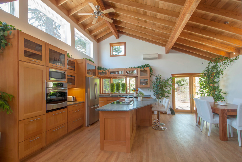 Inspiration for a large contemporary l-shaped light wood floor and brown floor eat-in kitchen remodel in San Francisco with an undermount sink, shaker cabinets, medium tone wood cabinets, soapstone countertops, stainless steel appliances and an island