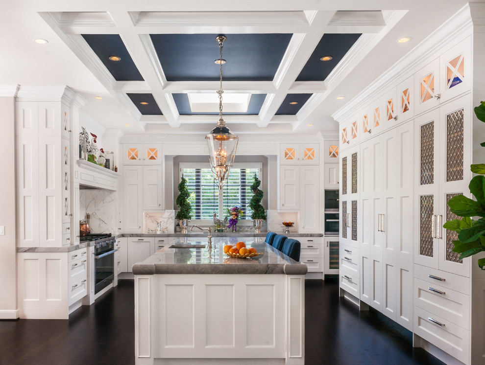 Example of a large classic u-shaped dark wood floor kitchen pantry design in San Francisco with a double-bowl sink, shaker cabinets, white cabinets, granite countertops, white backsplash, stone slab backsplash, stainless steel appliances and an island
