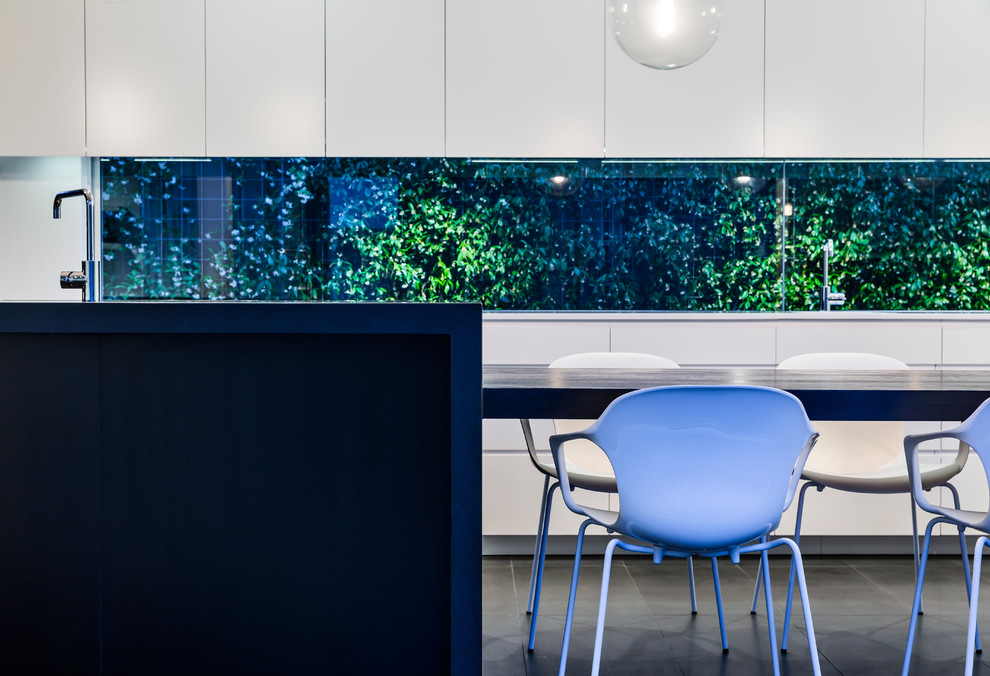 Photo of a contemporary kitchen in Sydney with a submerged sink, flat-panel cabinets, white cabinets, wood worktops and an island.