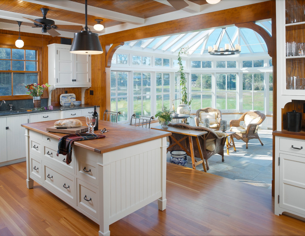 Example of a classic kitchen design in Providence with wood countertops