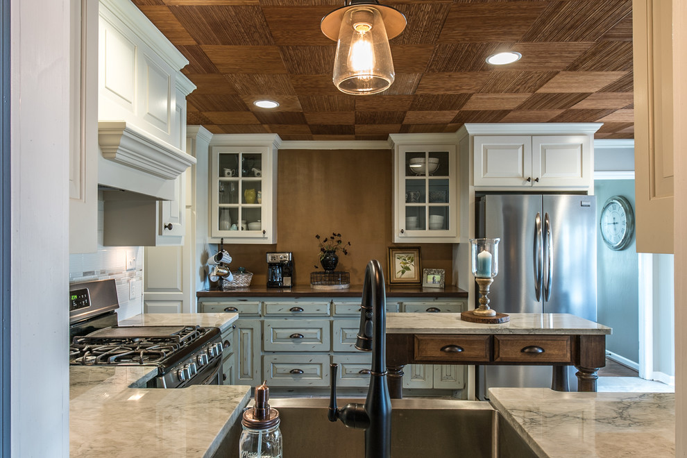 Inspiration for a mid-sized timeless l-shaped eat-in kitchen remodel in Other with a farmhouse sink, quartzite countertops, white backsplash, porcelain backsplash, stainless steel appliances and an island