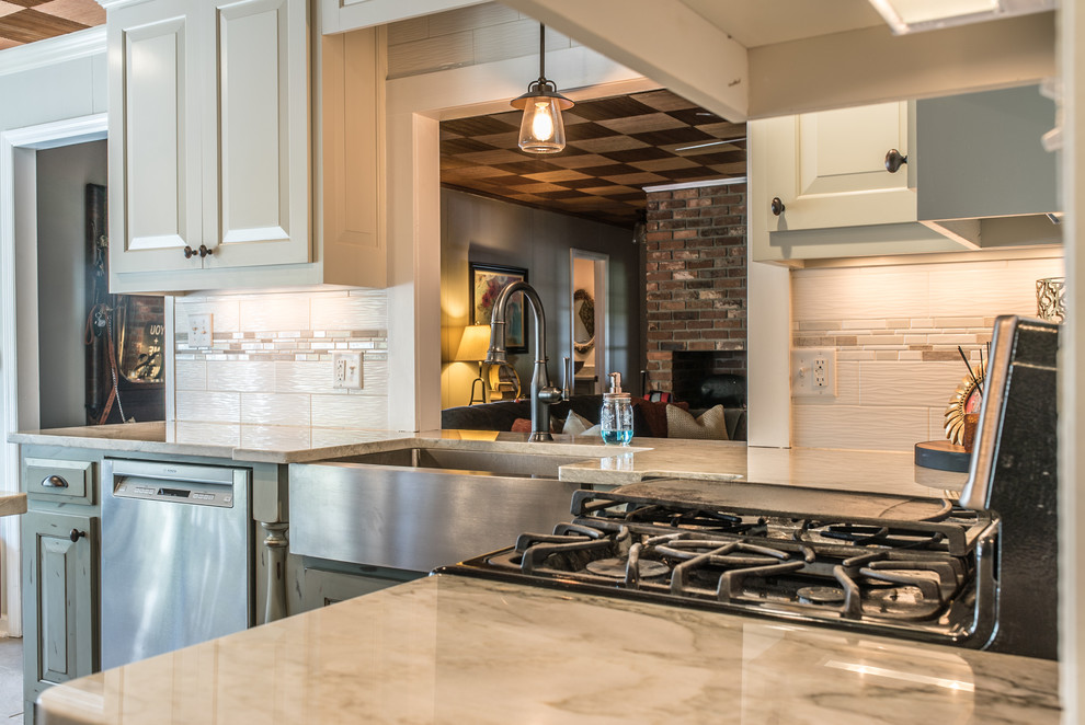 Example of a trendy l-shaped eat-in kitchen design in Other with a farmhouse sink, shaker cabinets, white cabinets, quartzite countertops, multicolored backsplash, ceramic backsplash, stainless steel appliances and an island