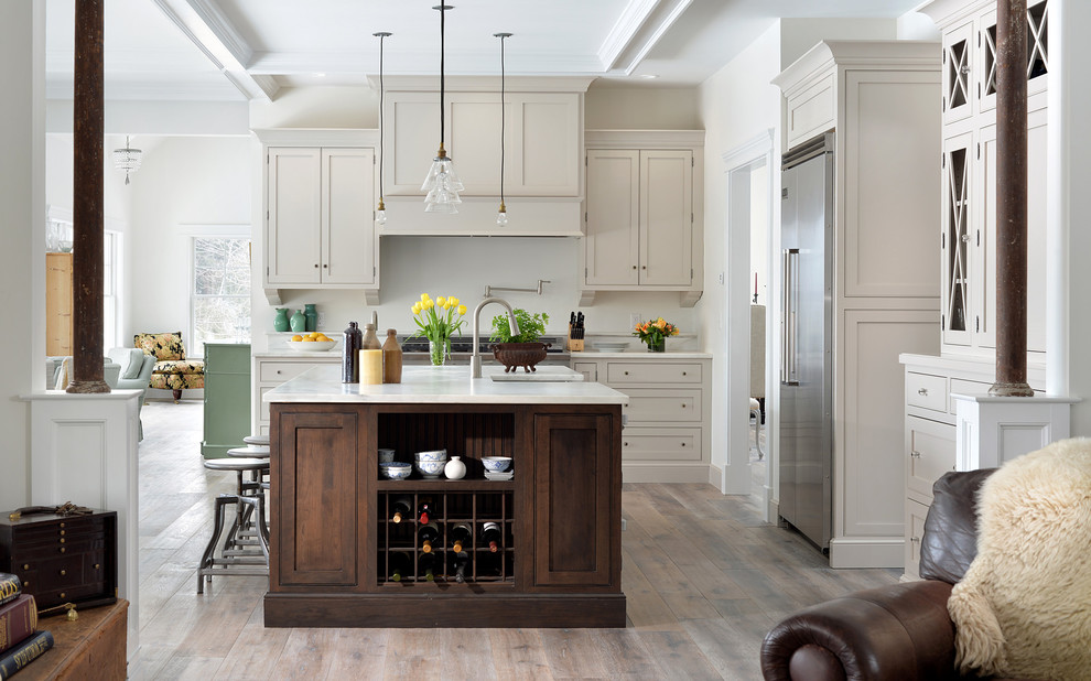 Transitional medium tone wood floor kitchen photo in Atlanta with shaker cabinets, gray cabinets, stainless steel appliances and an island