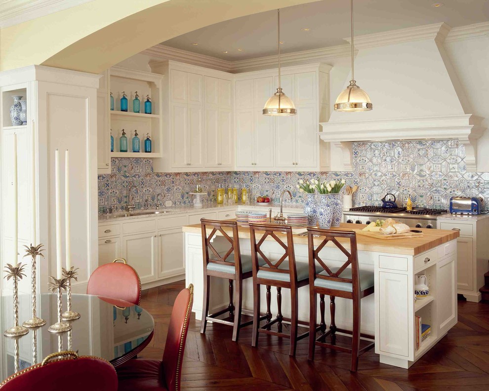 Eat-in kitchen - traditional eat-in kitchen idea in San Francisco with ceramic backsplash, stainless steel appliances, an undermount sink, shaker cabinets, white cabinets, wood countertops and multicolored backsplash