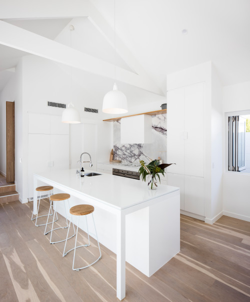 Scandinavian Elegance: Modern White Kitchen Cabinets with a Marble Backsplash