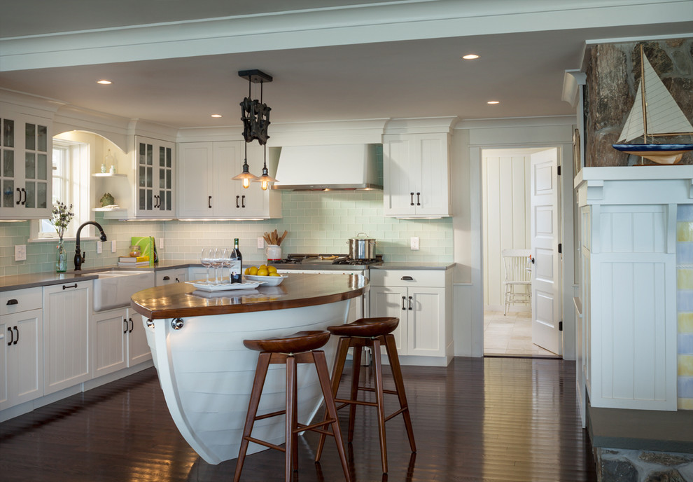 Beach style l-shaped dark wood floor kitchen photo in Providence with a farmhouse sink, recessed-panel cabinets, white cabinets, blue backsplash and glass tile backsplash