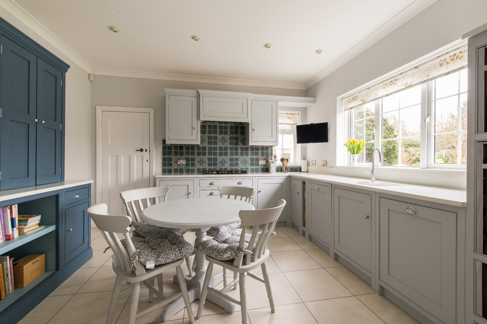 Photo of a nautical l-shaped kitchen/diner in Kent with a submerged sink, shaker cabinets, grey cabinets, blue splashback, no island, beige floors and white worktops.