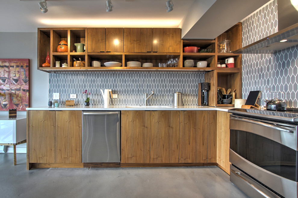 Inspiration for a small contemporary l-shaped concrete floor kitchen remodel in Seattle with flat-panel cabinets, dark wood cabinets, quartz countertops, blue backsplash, ceramic backsplash and stainless steel appliances