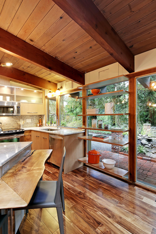 Eat-in kitchen - small mid-century modern l-shaped medium tone wood floor eat-in kitchen idea in Seattle with an island, flat-panel cabinets, light wood cabinets, marble countertops, multicolored backsplash, stainless steel appliances and a single-bowl sink