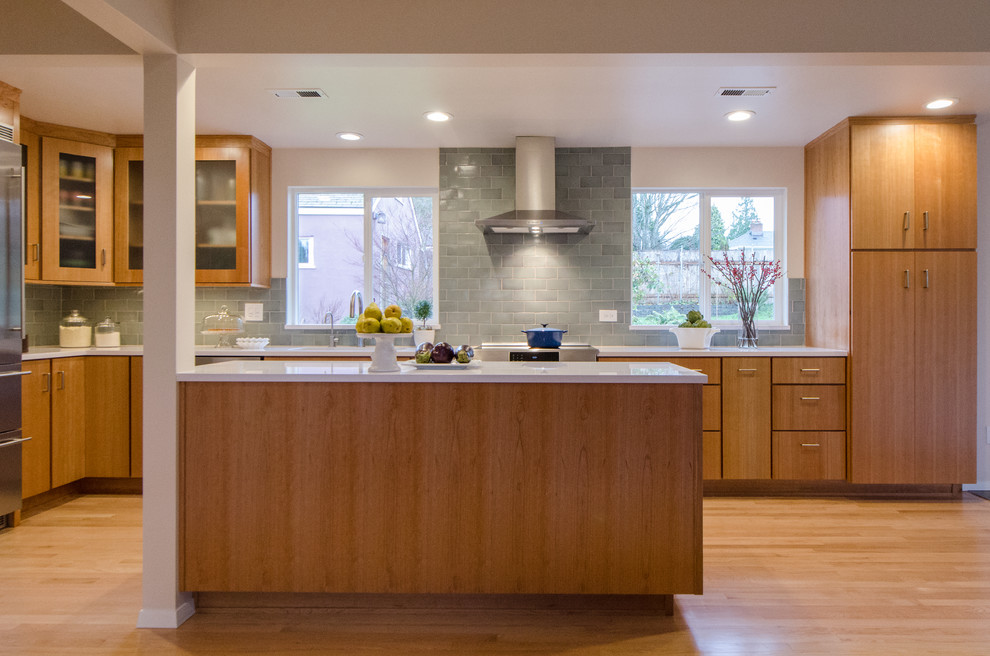 Mid-sized transitional l-shaped light wood floor kitchen photo in Seattle with an undermount sink, flat-panel cabinets, medium tone wood cabinets, ceramic backsplash, stainless steel appliances and an island