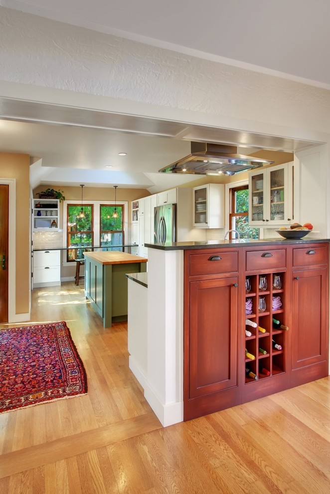 Inspiration for a mid-sized craftsman l-shaped light wood floor eat-in kitchen remodel in Seattle with shaker cabinets, medium tone wood cabinets and two islands