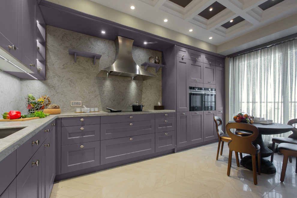 This is an example of a large bohemian l-shaped open plan kitchen in Other with a double-bowl sink, louvered cabinets, purple cabinets, engineered stone countertops, beige splashback, stone slab splashback, coloured appliances, ceramic flooring, a breakfast bar, beige floors and beige worktops.